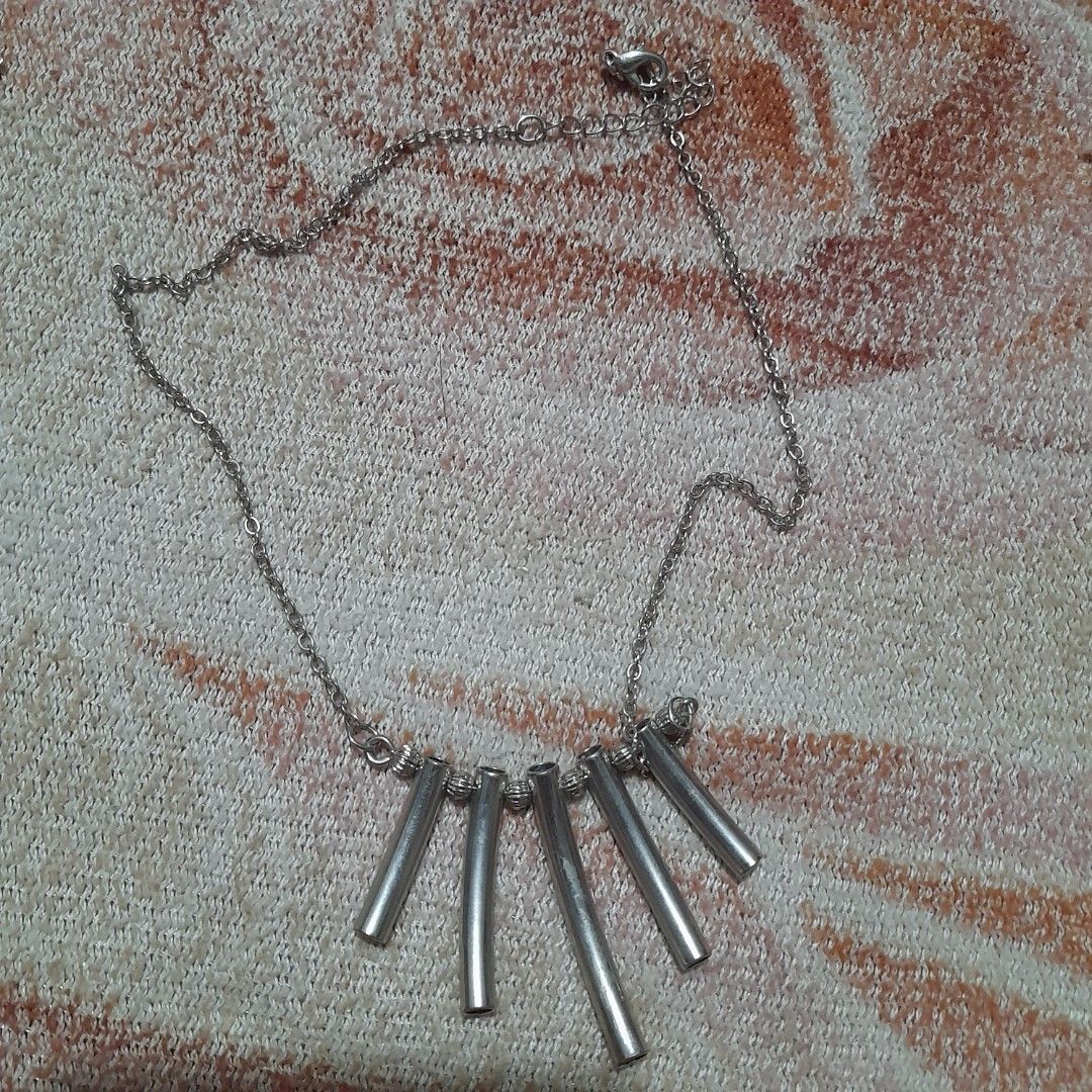 Bar Pendant Necklace (Category: Necklaces) located in Bocaue. Submitted by marajapansurplus (Listing ID 1463802002, Image 3). Description: - Simple silver toned necklace with a chain. - Features a unique pendant made of five silver bars. - Standard clasp closure for secure wear. - Minimalist design, ideal for everyday style. - Great for layering with other necklaces..
