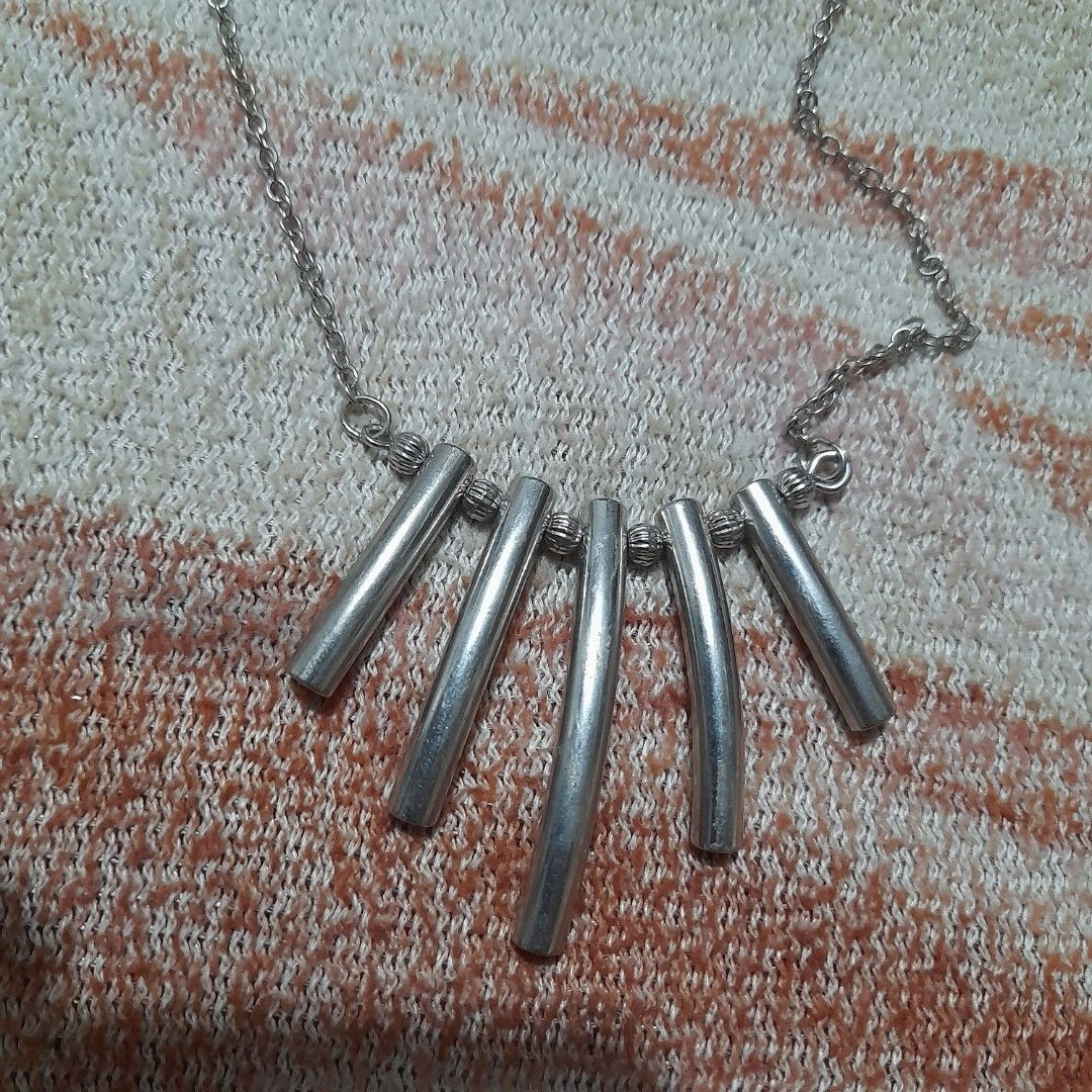 Bar Pendant Necklace (Category: Necklaces) located in Bocaue. Submitted by marajapansurplus (Listing ID 1463802002, Image 1). Description: - Simple silver toned necklace with a chain. - Features a unique pendant made of five silver bars. - Standard clasp closure for secure wear. - Minimalist design, ideal for everyday style. - Great for layering with other necklaces..