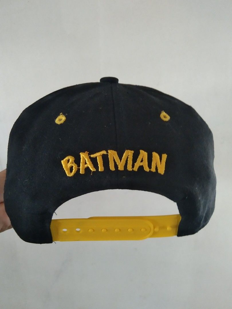 Batman Snapback Cap Black Yellow (Category: Caps & Hats) located in Manila. Submitted by tonycess16 (Listing ID 1463921544, Image 2). Description: - Cool Batman snapback cap - Black with yellow brim - Features iconic Batman logo on the front - 'BATMAN' text embroidered on the back - Adjustable strap for a comfortable fit - Unique Gotham City graphic print on the inside brim - A must-have for any Batman enthusiast.