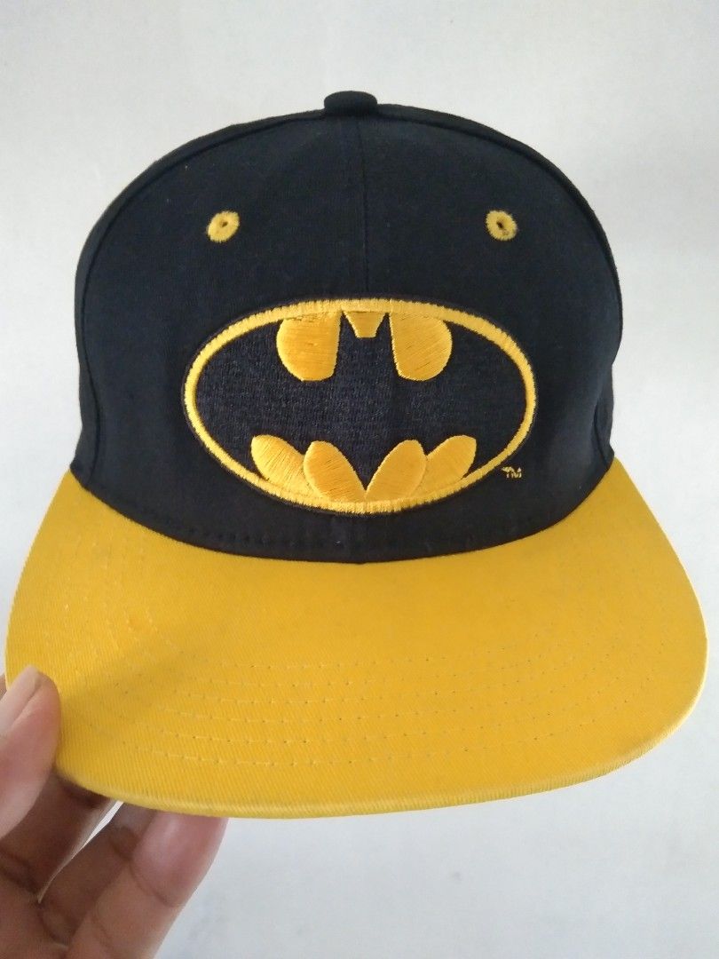 Batman Snapback Cap Black Yellow (Category: Caps & Hats) located in Manila. Submitted by tonycess16 (Listing ID 1463921544, Image 1). Description: - Cool Batman snapback cap - Black with yellow brim - Features iconic Batman logo on the front - 'BATMAN' text embroidered on the back - Adjustable strap for a comfortable fit - Unique Gotham City graphic print on the inside brim - A must-have for any Batman enthusiast.