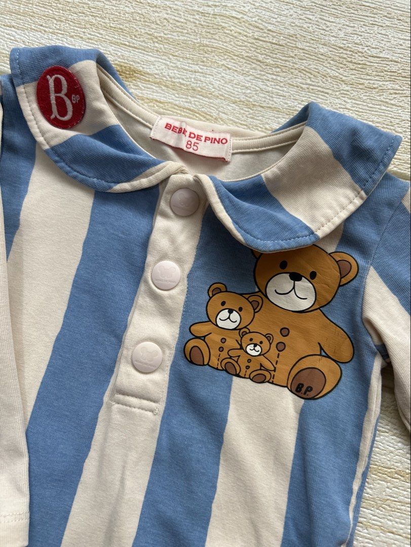 Bebe De Pino bear bodysuit (Category: Babies & Kids Fashion) located in Cebu City. Submitted by yjainani (Listing ID 1463748706, Image 2). Description: blue and beige striped baby bodysuit with a teddy bear graphic and a sailor-style collar from Bebe De Pino 6-12m.