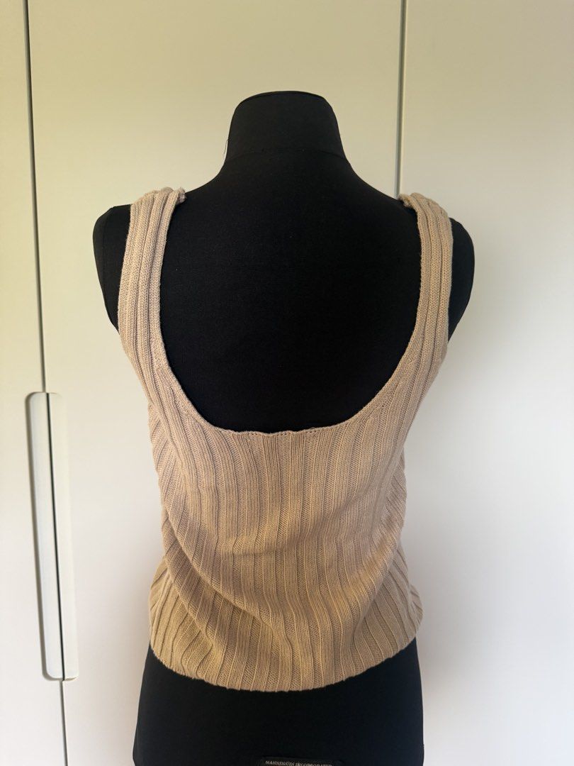 Beige Ribbed Button-Up Tank Top (Category: Sleeveless) located in Manila. Submitted by cristycrab247 (Listing ID 1463773312, Image 3). Description: - Beige ribbed tank top - Square neckline - Button details down the front - Estimated size: Small to Medium - Minor marks on front (refer to close-up photo) - Versatile for layering or wearing solo.