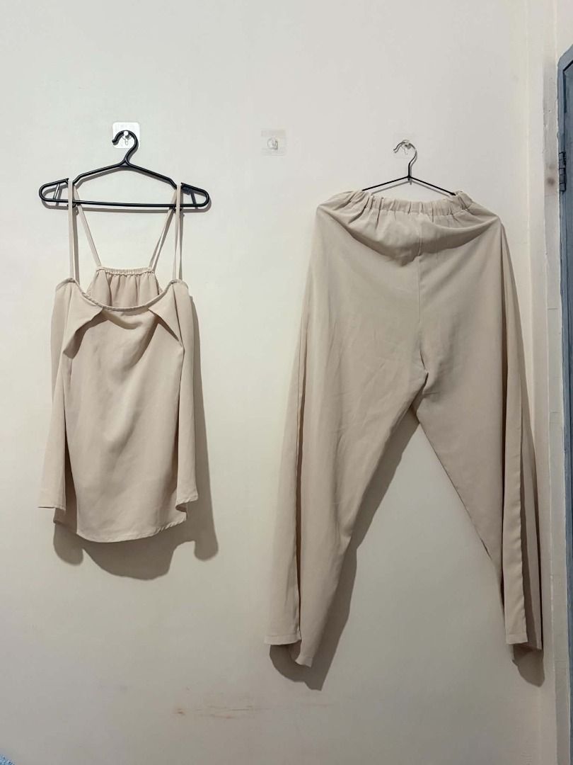 Beige Spaghetti Strap Top and Pants Set (Category: Sets or Coordinates) located in San Leonardo. Submitted by burgossanleonardo.12345 (Listing ID 1463911053, Image 1). Description: - Beige spaghetti strap top with wide sleeves - Matching elastic waist pants - Lightweight and flowy fabric - Versatile for casual or dressed-up occasions - Ideal for warmer weather - Easy to mix and match with your wardrobe.