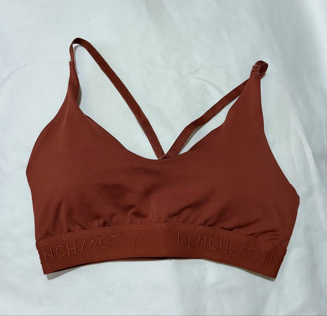Bench Active Sports Bra (Category: Activewear) located in Paranaque City. Submitted by declutternsell.729 (Listing ID 1463774243, Image 2). Description: - Bench Active sports bra in a chic rust color. - Stylish criss-cross strap design at the back. - Comfortable elasticated band with Bench/Active logo. - Material: 92% polyester, 8% elastane for a good stretch. - Care instructions: Hand wash in lukewarm water only. Do not bleach, tumble dry, or ir