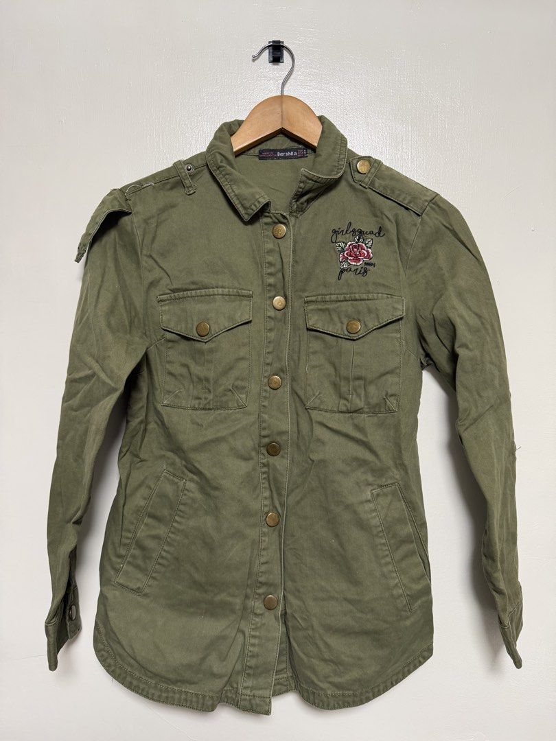 Bershka Olive Green Embroidered Rose Jacket (Category: Coats, Jackets and Outerwear) located in Manila. Submitted by don_p (Listing ID 1463862854, Image 1). Description: S to M - Olive green jacket - Cool rose embroidery on the back - "Dreamer" ribbon detail on the rose - Button-up front - Pockets included - Shoulder epaulets - Button cuffs - Ideal for layering.