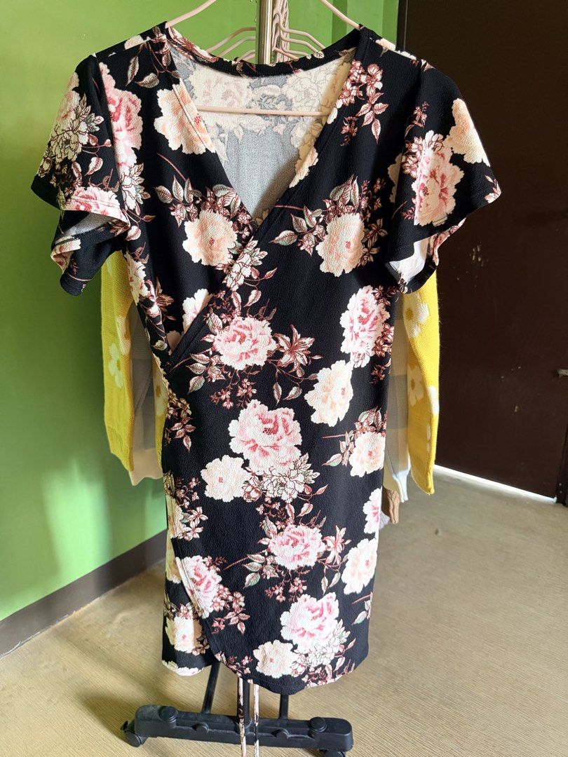 Black Floral Wrap Dress (Category: Dresses) located in Muntinlupa City. Submitted by cocofinds023 (Listing ID 1463749813, Image 1). Description: - Flattering black wrap dress - Pretty pink and white floral print - V-neckline - Short flutter sleeves - Slightly textured fabric - Versatile: great for casual or dressed-up looks.