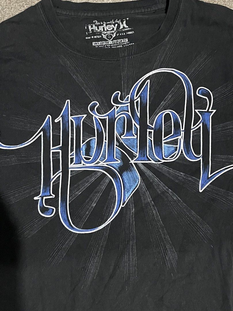Black Hurley Graphic T-Shirt (Category: Tshirts & Polo Shirts ) located in Manila. Submitted by yhn67 (Listing ID 1463867147, Image 3). Description: - Black Hurley T-shirt - Features a cool blue graphic design on the front - Short sleeves and crew neck - Made of 100% cotton - Ideal for casual wear - Pairs easily with jeans or shorts.