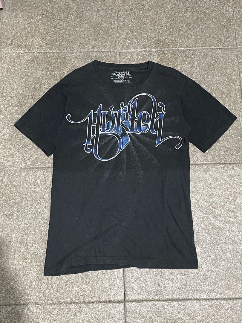 Black Hurley Graphic T-Shirt (Category: Tshirts & Polo Shirts ) located in Manila. Submitted by yhn67 (Listing ID 1463867147, Image 1). Description: - Black Hurley T-shirt - Features a cool blue graphic design on the front - Short sleeves and crew neck - Made of 100% cotton - Ideal for casual wear - Pairs easily with jeans or shorts.