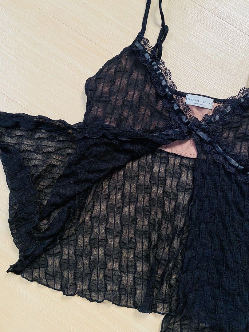 Black Lace Trim Camisole Top (Category: Sleeveless) located in Vigan. Submitted by yourcloset1001 (Listing ID 1463902350, Image 2). Description: - Brand: Frankee + Skylark - Color: Black - Style: Camisole top - Fabric: Textured with sheer overlay - Details: Lace trim on neckline and hem, ribbon details, tie at bust - Straps: Adjustable - Size: L.