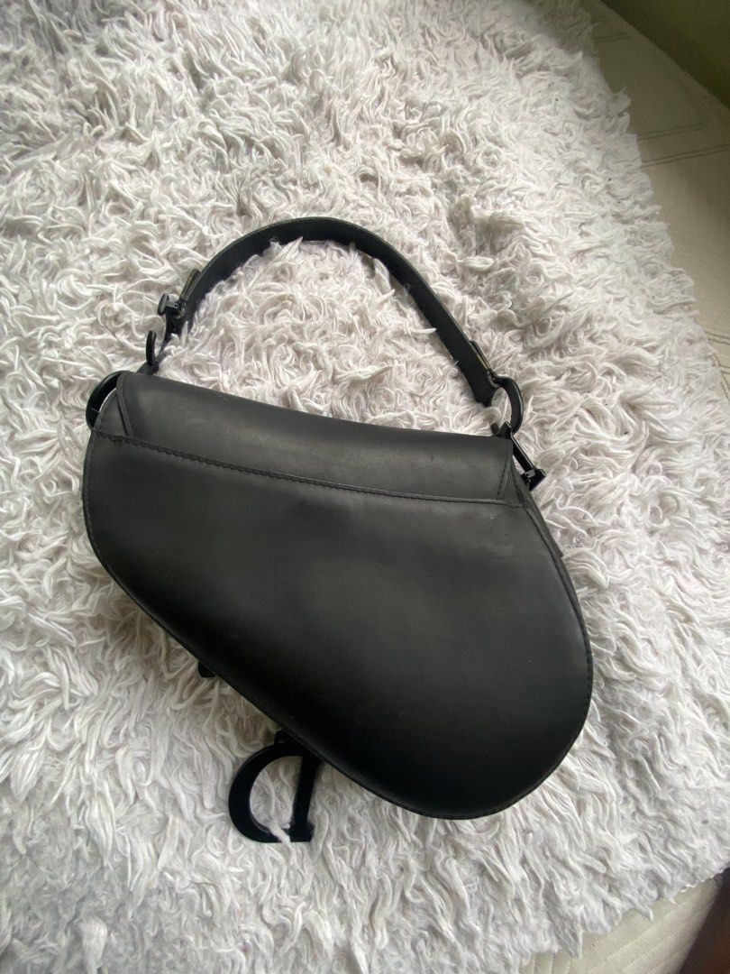 Black Leather Dior Saddle Bag (Category: Luxury Bags & Wallets) located in Manila. Submitted by geminibibo (Listing ID 1463805580, Image 2). Description: Classic black leather Dior saddle bag with 'D' charm. Features interior zip pocket and adjustable strap. Perfect for everyday or special events. Comes with the dust bag and box 🖤.