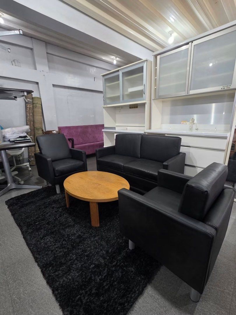 Black Leather Sofa, 2 Armchairs, Coffee Table, and Shelving Unit (Category: Sofas) located in Baguio. Submitted by nileh (Listing ID 1463760096, Image 3). Description: - Complete living room set - Black leather 2-seater sofa - Two matching black leather armchairs - Round wooden coffee table - Large white shelving unit with glass doors - Ideal for home or office spaces - Items sold as a complete set Imported Sofa Set from Japan 2 seater & 2 pcs Si