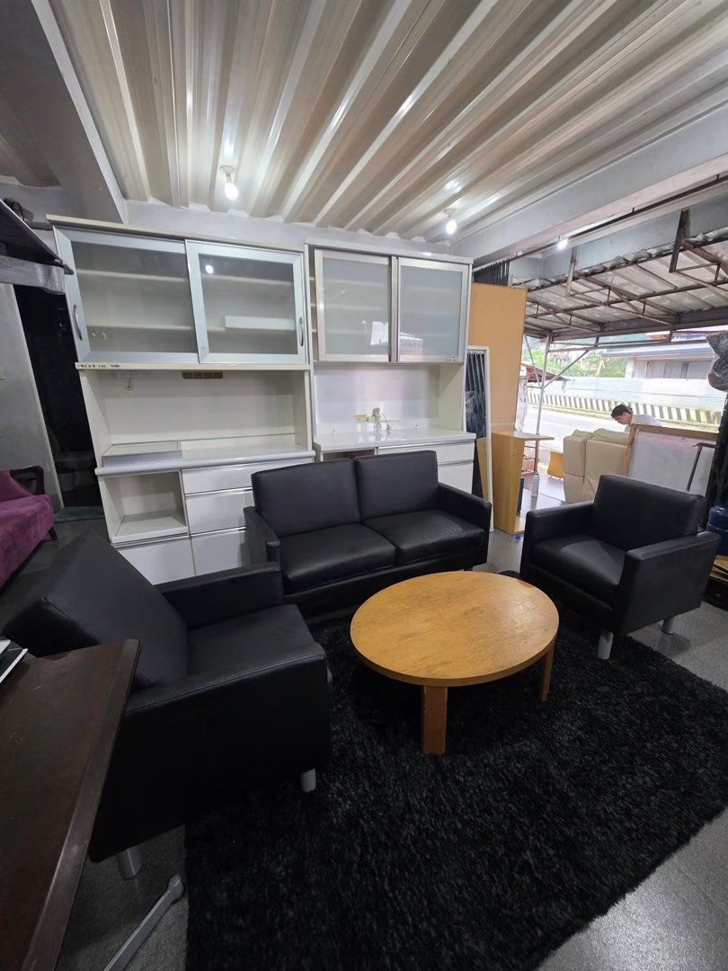 Black Leather Sofa, 2 Armchairs, Coffee Table, and Shelving Unit (Category: Sofas) located in Baguio. Submitted by nileh (Listing ID 1463760096, Image 2). Description: - Complete living room set - Black leather 2-seater sofa - Two matching black leather armchairs - Round wooden coffee table - Large white shelving unit with glass doors - Ideal for home or office spaces - Items sold as a complete set Imported Sofa Set from Japan 2 seater & 2 pcs Si