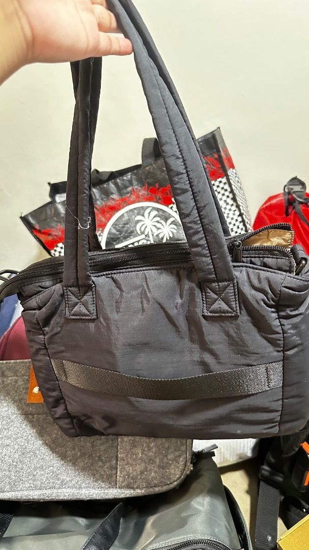 Black Puffer Tote Bag (Category: Tote Bags) located in Quezon City. Submitted by macelpain (Listing ID 1463742390, Image 2). Description: -Preloved - compartment of laptop 13inch - Stylish black puffer tote bag - Convenient zippered front pocket - Durable fabric straps - Ideal size for daily use - Spacious interior for all your essentials.