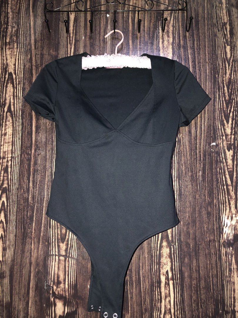 Black Short Sleeve V-Neck Bodysuit (Category: Blouses) located in Manila. Submitted by zhala_dawn3 (Listing ID 1463745857, Image 1). Description: - Black short sleeve bodysuit - Flattering V-neckline - Comfortable stretchy material - Secure snap closure at the bottom - Versatile for layering or wearing on its own.
