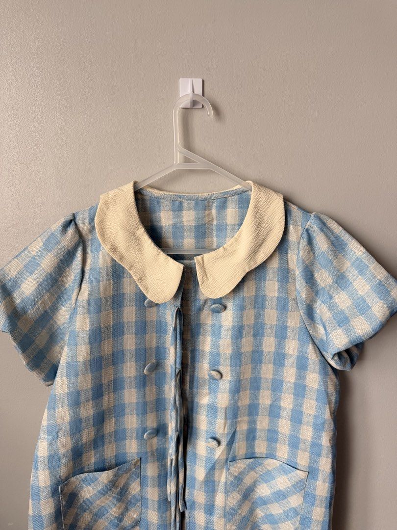 Blue and White Gingham Peter Pan Collar Dress (Category: Dresses) located in Quezon City. Submitted by ninny.ph (Listing ID 1463817605, Image 2). Description: - Adorable blue and white gingham pattern - Classic Peter Pan collar - Stylish double-breasted button detail - Two functional front pockets - Comfortable short sleeves - Effortlessly achieve a retro look - Versatile and easy to style.