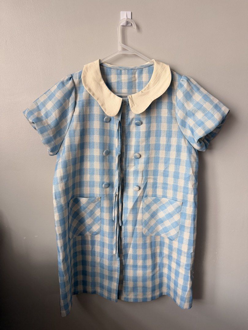 Blue and White Gingham Peter Pan Collar Dress (Category: Dresses) located in Quezon City. Submitted by ninny.ph (Listing ID 1463817605, Image 1). Description: - Adorable blue and white gingham pattern - Classic Peter Pan collar - Stylish double-breasted button detail - Two functional front pockets - Comfortable short sleeves - Effortlessly achieve a retro look - Versatile and easy to style.