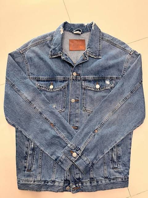 Blue Denim Jacket with Distressed Details (Category: Coats, Jackets and Outerwear) located in Manila. Submitted by flrntsanc17840 (Listing ID 1463837864, Image 1). Description: Size 13-14 kids size, pero kasya sa S na adult. Never pang nagamit. Natanggal lang tag. - Classic blue denim jacket - Distressed collar and hem for a rugged look - Two chest pockets with secure button closures - Easy button-up front - Perfect for layering or wearing on its