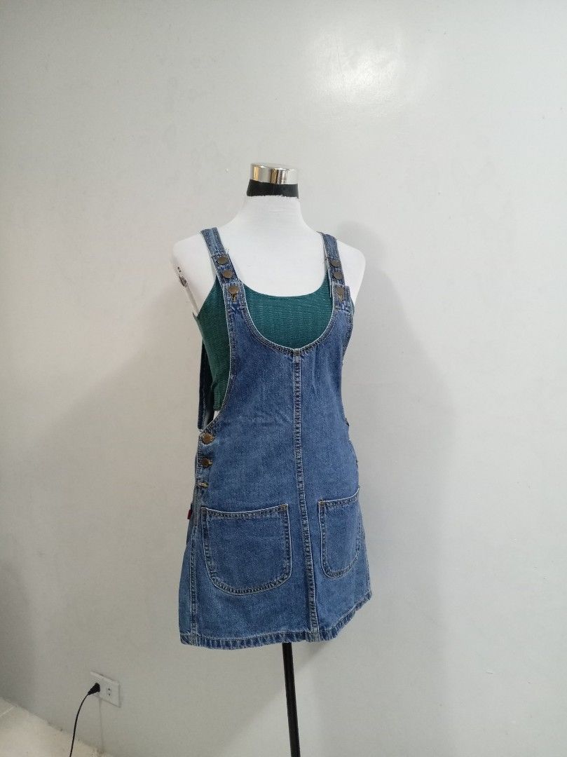 Blue Denim Pinafore romper skirt (Category: Rompers) located in Paranaque City. Submitted by janella11 (Listing ID 1463772736, Image 1). Description: - Adorable blue denim pinafore romper skirt - Features two front pockets - Button details on the side - Adjustable straps with buttons for a perfect fit - Ideal for layering over tops or tees - Effortless to wear and style for a casual look.