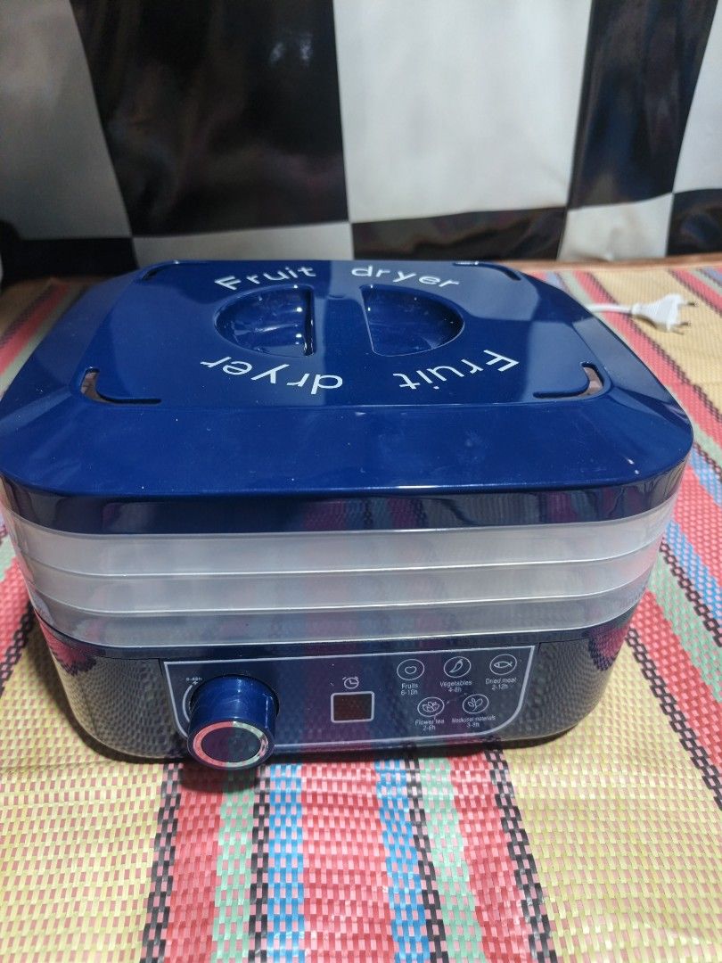Blue Fruit Dryer with Multiple Trays (Category: Food Organization & Storage) located in Manila. Submitted by libbyjoyre07182 (Listing ID 1463829056, Image 1). Description: - Blue fruit dryer with multiple trays - Features a digital display and control knob - Ideal for drying fruits, herbs, and other food items - Simple and easy to operate - Compact design for convenient storage.