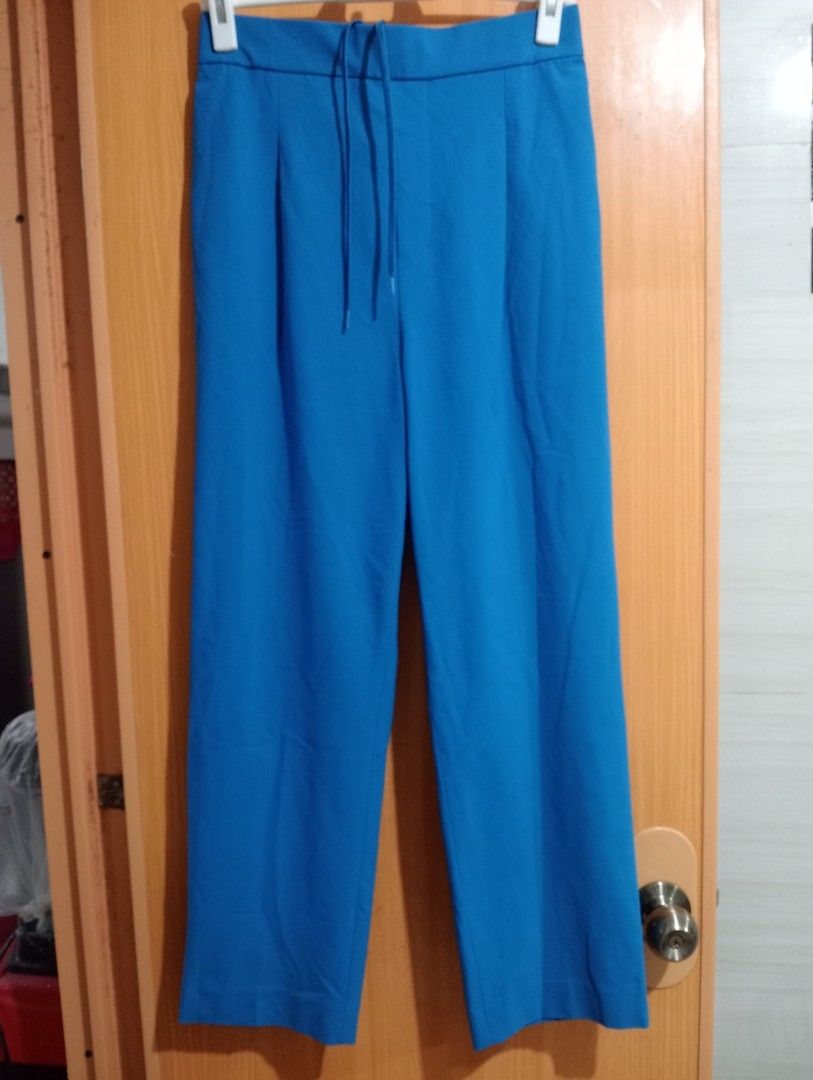 Blue Wide Leg Pants with Drawstring Waist (Category: Jeans) located in Quezon City. Submitted by niceoutfits (Listing ID 1463742663, Image 2). Description: - Blue wide-leg pants - Elastic waistband with drawstring tie - Pleated front detail - Two side pockets - Back pockets included - Comfortable and casual design - Ideal for everyday wear.