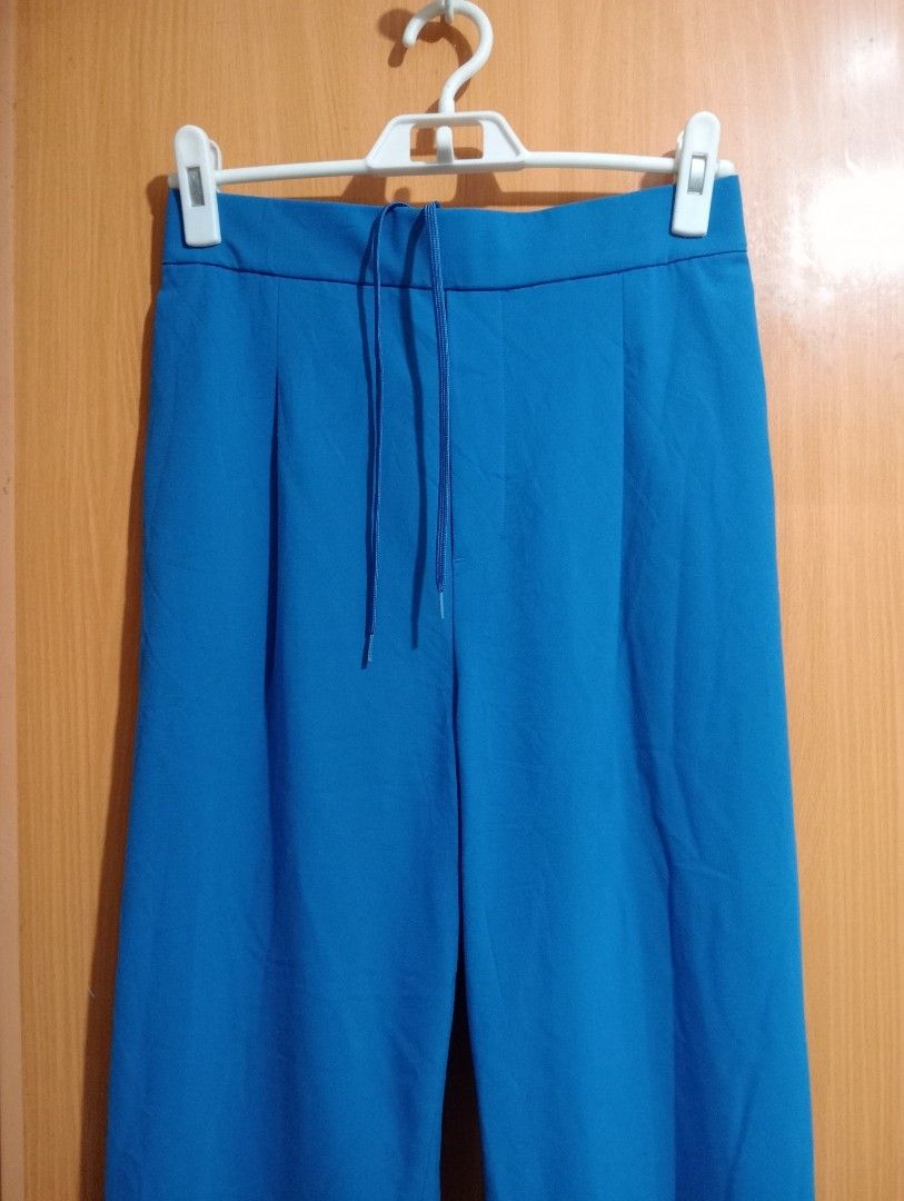 Blue Wide Leg Pants with Drawstring Waist (Category: Jeans) located in Quezon City. Submitted by niceoutfits (Listing ID 1463742663, Image 3). Description: - Blue wide-leg pants - Elastic waistband with drawstring tie - Pleated front detail - Two side pockets - Back pockets included - Comfortable and casual design - Ideal for everyday wear.