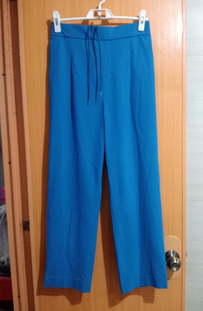 Blue Wide Leg Pants with Drawstring Waist (Category: Jeans) located in Quezon City. Submitted by niceoutfits (Listing ID 1463742663, Image 1). Description: - Blue wide-leg pants - Elastic waistband with drawstring tie - Pleated front detail - Two side pockets - Back pockets included - Comfortable and casual design - Ideal for everyday wear.