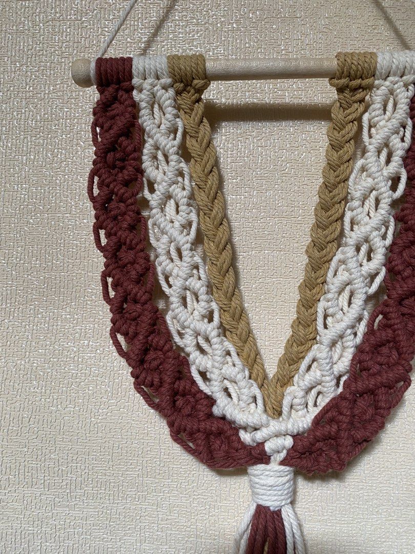 Rush SALE Boho Macrame Wall Hanging Decor (Category: Wall Decor) located in Caloocan City. Submitted by wearprelovedmnl (Listing ID 1463785117, Image 3). Description: - Handmade macrame wall hanging - Features a beautiful layered design - Colors: Maroon, white, and tan cords - Mounted on a wooden dowel - Adds a bohemian touch to any room - Perfect for living rooms, bedrooms, or nurseries - Unique home decor piece.