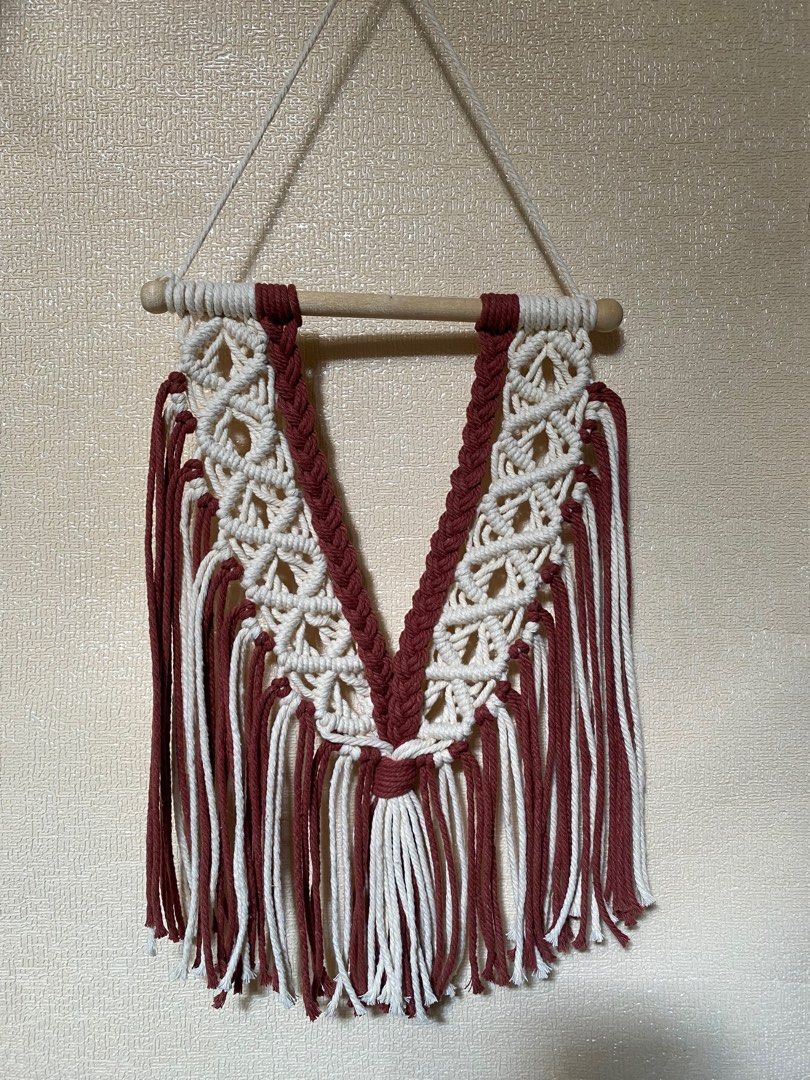 RUSH SALE Boho Macrame Wall Hanging Tapestry Decor (Category: Wall Decor) located in Caloocan City. Submitted by mamamo.to (Listing ID 1463785046, Image 1). Description: - Handmade macrame wall hanging - Beautiful cream and burgundy colors - Mounted on a wooden dowel - Perfect for adding a boho vibe to your space - Ideal for living rooms, bedrooms, or nurseries - Unique texture and design.