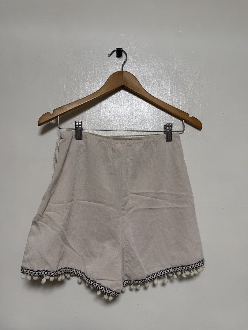 SHEIN - Boho Pom Pom Trim Wrap Shorts (Category: Shorts) located in Manila. Submitted by don_p (Listing ID 1463866029, Image 2). Description: S to M - Lightweight wrap shorts - Adorable pom pom trim - Convenient side tie detail - Natural, textured fabric - Ideal for casual outings or beach days - Effortless to style.