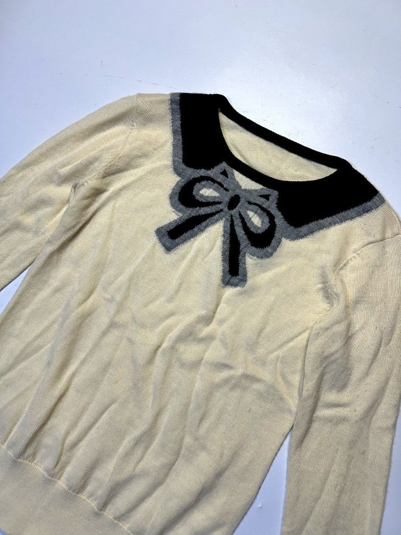 Bow Cream Knitted Sweater (Category: Longsleeves) located in Marikina City. Submitted by wearablearttt (Listing ID 1463932155, Image 1). Description: Bow Cream Knitted Sweater 𖨆 LAID FLAT MEASUREMENTS ‎L 22" ‎W 14-17.5".