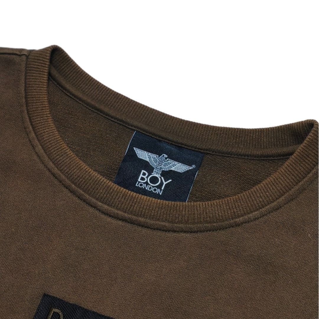 BOY London Eagle Logo Zip Pocket Sweatshirt (Category: Coats, Jackets and Outerwear) located in Meycauayan. Submitted by thrifting_gorilla (Listing ID 1463930958, Image 3). Description: - Authentic BOY London sweatshirt - 22 X 25 - Sleeves: 22 - Full embroidered Iconic eagle and 'BOY' logo prominently displayed on the back - Convenient zip pocket detail on the front - 'BOY LONDON' tag intact - Ideal for everyday casual wear.