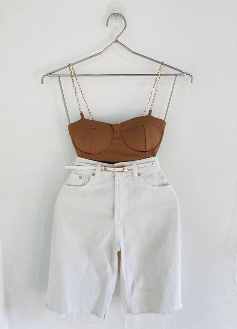 Brown Bustier Top & White Denim Shorts Set (Category: Sets or Coordinates) located in Vigan. Submitted by yourcloset1001 (Listing ID 1463914368, Image 1). Description: - Cute brown bustier top with stylish chain straps. - High-waisted white denim shorts with a trendy frayed hem. - Includes a white belt with a chic gold buckle. - Versatile outfit for casual outings or nights out. - Mix and match pieces with your existing wardrobe..