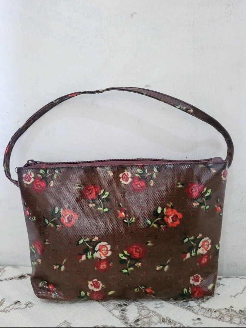 Brown Floral PVC Mini Handbag (Category: Purses & Pouches) located in Balanga. Submitted by marae_c (Listing ID 1463754369, Image 1). Description: In very good condition. Like new. Very pretty in actual. Water resistant. perfect lil bag for your kikay needs. Kasya rin phone here. *Ca.th ki.dston vibes.