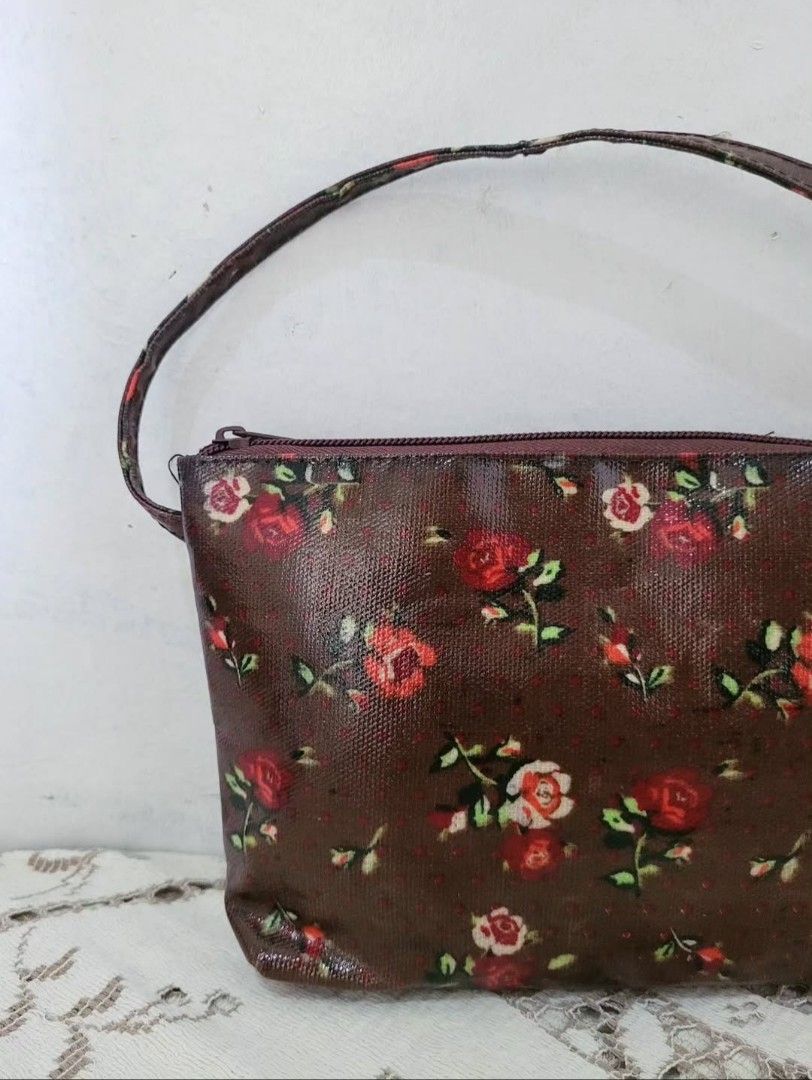Brown Floral PVC Mini Handbag (Category: Purses & Pouches) located in Balanga. Submitted by marae_c (Listing ID 1463754369, Image 2). Description: In very good condition. Like new. Very pretty in actual. Water resistant. perfect lil bag for your kikay needs. Kasya rin phone here. *Ca.th ki.dston vibes.