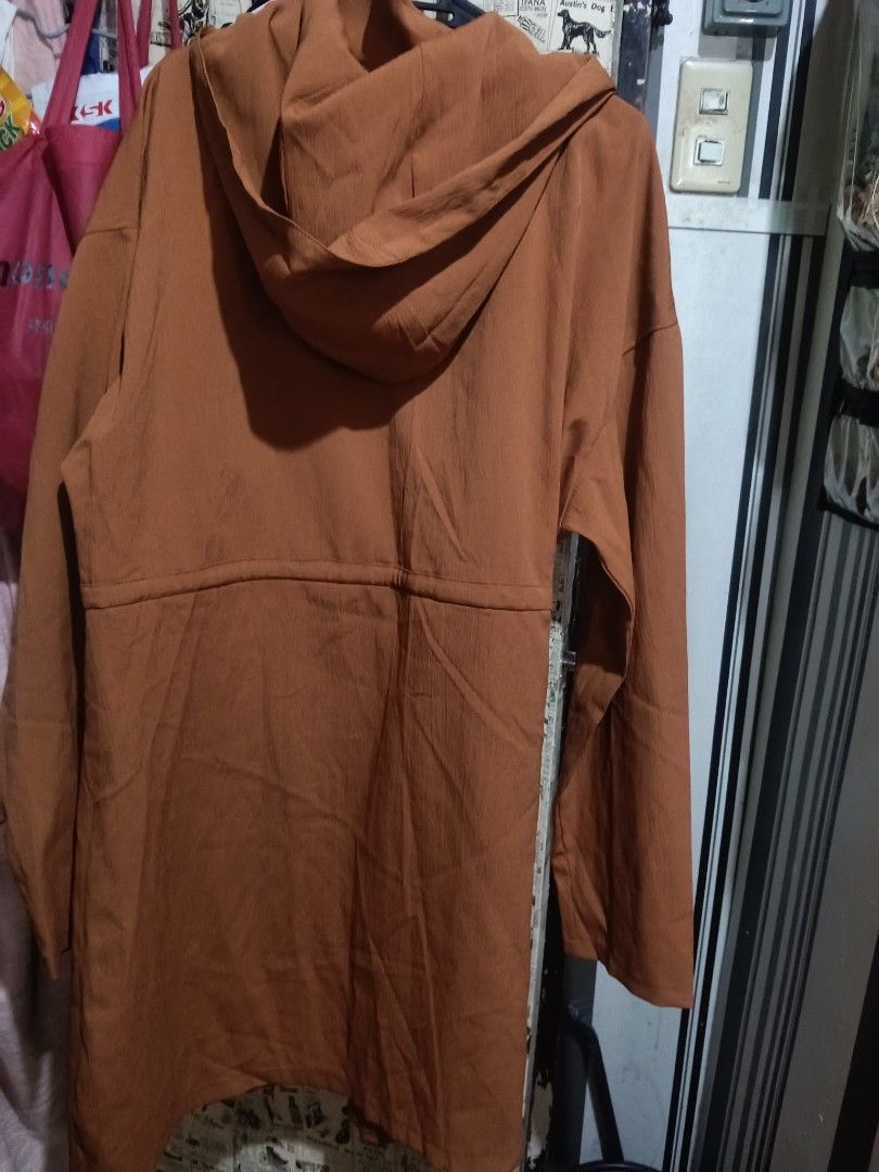 Brown Hooded Longline Jacket with Pockets (Category: Coats, Jackets and Outerwear) located in Quezon City. Submitted by bshoppe_ (Listing ID 1463765976, Image 2). Description: - Stylish brown longline jacket - Features a convenient hood - Secure zip and button front closure - Two spacious front pockets with button closures - Adjustable drawstring waist for a customizable fit - Ideal for layering and adding a chic touch to any outfit - size: xl-xx