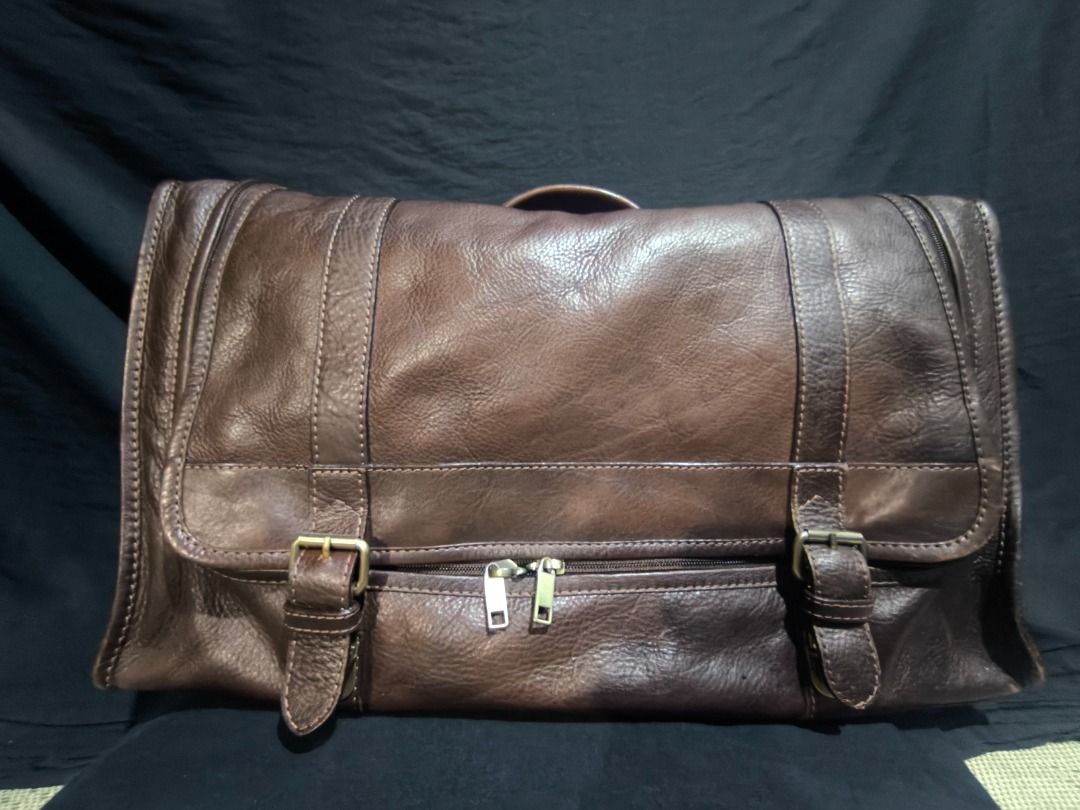 Brown Leather Messenger Bag with Buckle Straps (Category: Luxury Bags & Wallets) located in Manila. Submitted by weyvern28 (Listing ID 1463839337, Image 2). Description: - Cool brown leather messenger bag - Front buckle strap closure - Bright red fabric lining inside - Internal strap for securing items - Spacious design, perfect for carrying essentials.