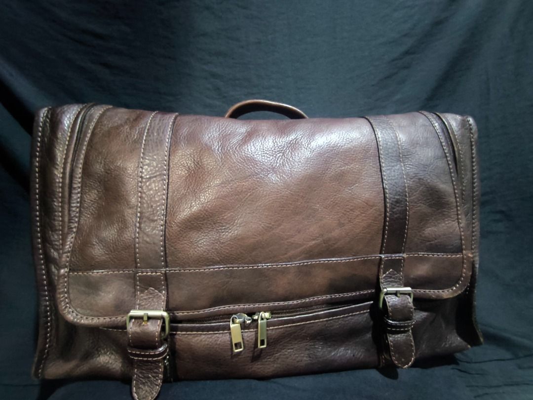 Brown Leather Messenger Bag with Buckle Straps (Category: Luxury Bags & Wallets) located in Manila. Submitted by weyvern28 (Listing ID 1463839337, Image 3). Description: - Cool brown leather messenger bag - Front buckle strap closure - Bright red fabric lining inside - Internal strap for securing items - Spacious design, perfect for carrying essentials.