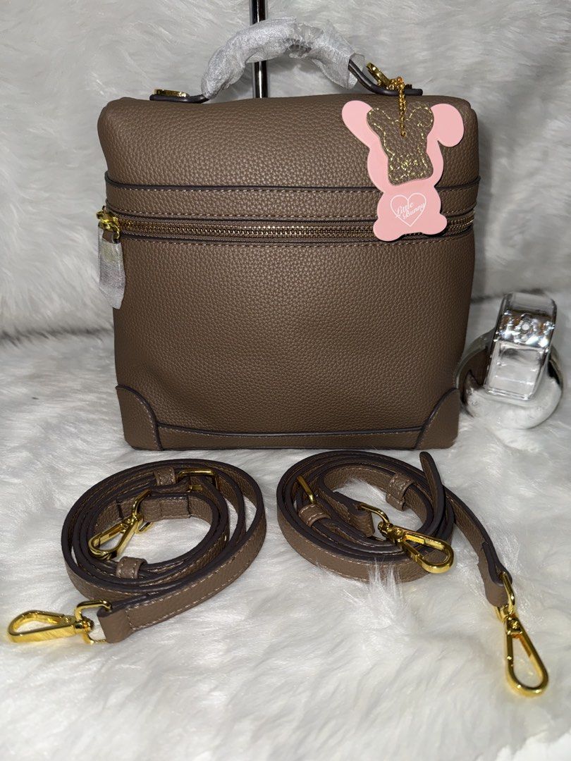 Brown Textured Leather Top Handle Bag with Straps (Category: Tote Bags) located in Taguig. Submitted by roseanneramirez (Listing ID 1463832437, Image 1). Description: - Chic brown textured leather bag - Versatile top handle design - Comes with two detachable shoulder straps (one long, one short) - Elegant gold hardware details - Secure zipper closure on top - Adorable pink bunny charm included.