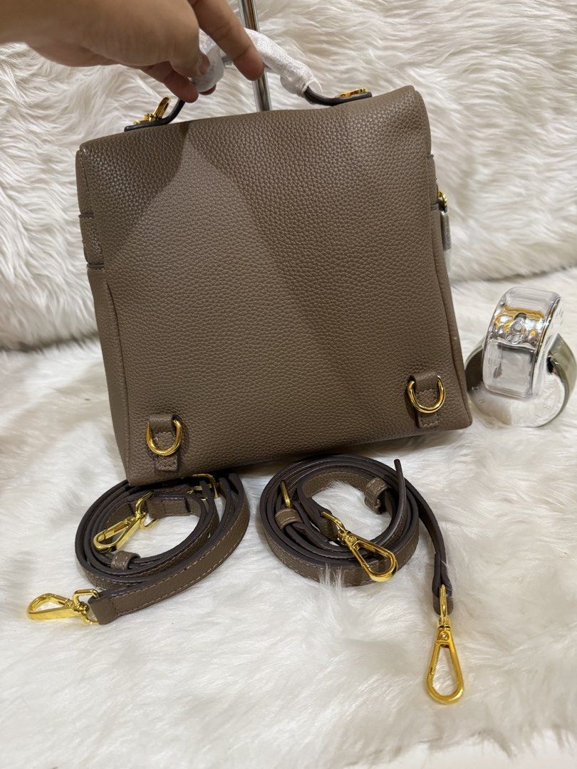Brown Textured Leather Top Handle Bag with Straps (Category: Tote Bags) located in Taguig. Submitted by roseanneramirez (Listing ID 1463832437, Image 2). Description: - Chic brown textured leather bag - Versatile top handle design - Comes with two detachable shoulder straps (one long, one short) - Elegant gold hardware details - Secure zipper closure on top - Adorable pink bunny charm included.