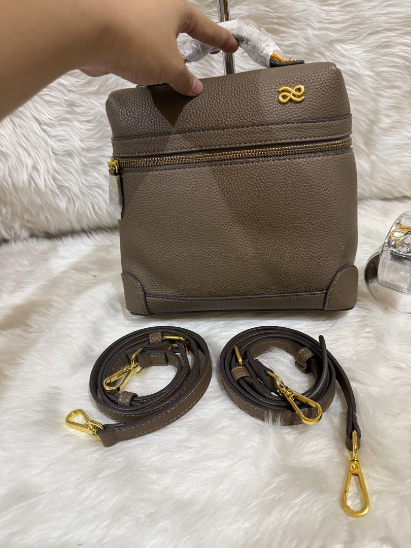 Brown Textured Leather Top Handle Bag with Straps (Category: Tote Bags) located in Taguig. Submitted by roseanneramirez (Listing ID 1463832437, Image 3). Description: - Chic brown textured leather bag - Versatile top handle design - Comes with two detachable shoulder straps (one long, one short) - Elegant gold hardware details - Secure zipper closure on top - Adorable pink bunny charm included.