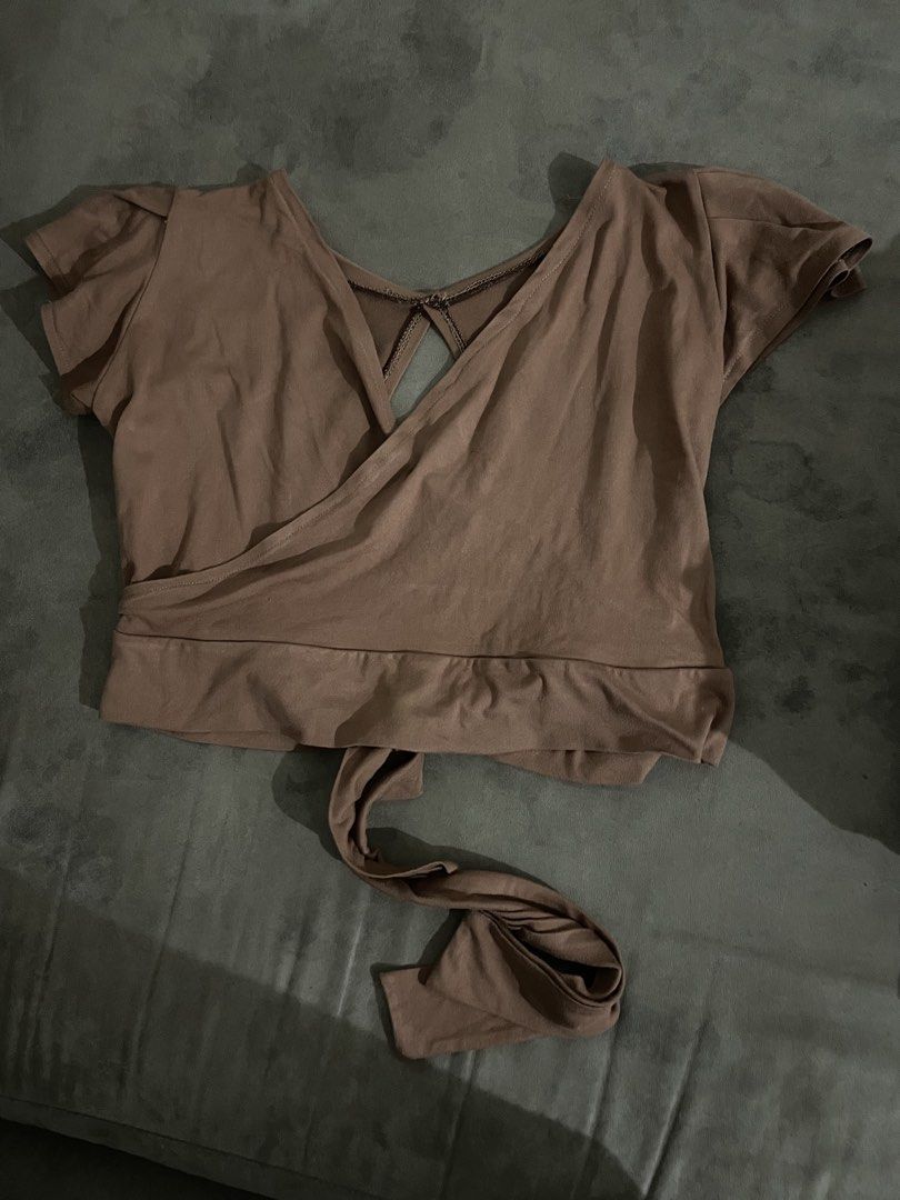 Brown Wrap Top with Tie Detail (Category: Blouses) located in Antipolo. Submitted by chicgrc (Listing ID 1463761597, Image 1). Description: 📍marikina / antipolo city 🚚 lalamove 💵 gcash / maya / gotyme - brown wrap top - Short sleeves - V-neckline - Tie detail at the waist - Open back with a cutout - Soft and comfortable fabric - Versatile for casual or dressed-up looks.