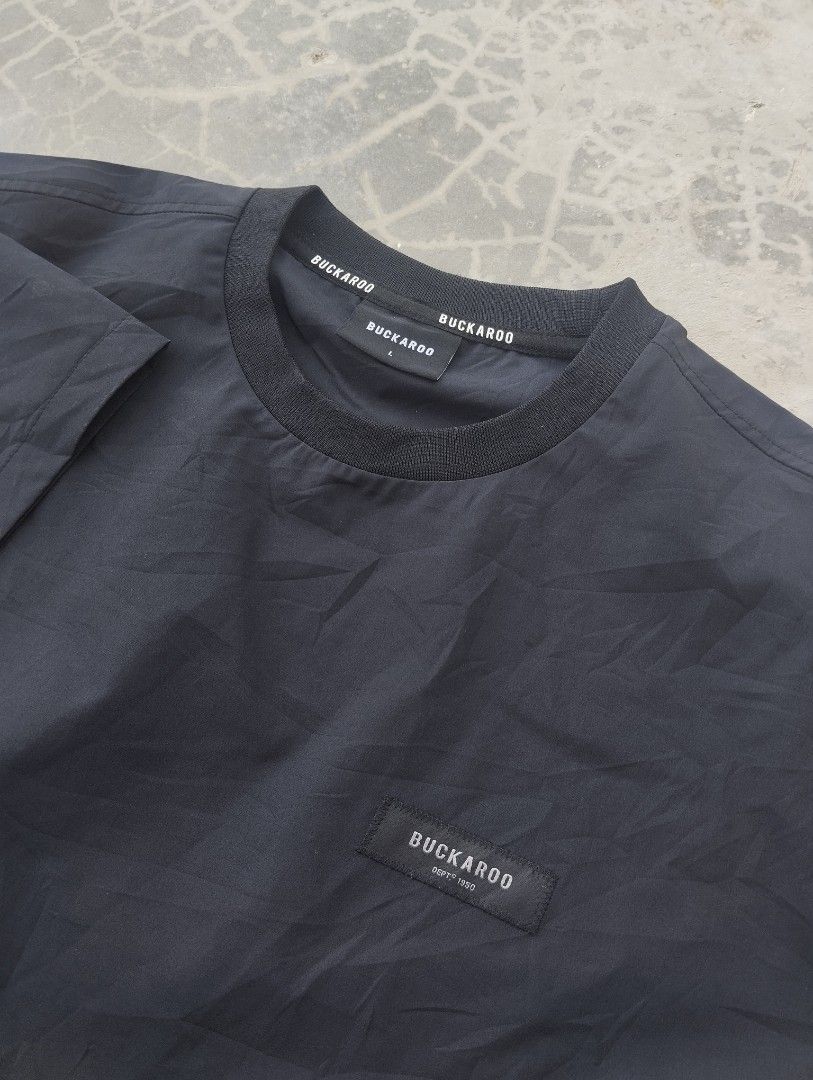 Buckaroo Black T-shirt (Category: Tshirts & Polo Shirts ) located in Mati. Submitted by old_era.ph (Listing ID 1463789928, Image 2). Description: - Classic black Buckaroo t-shirt - Features a small, discreet logo patch on the chest - Comfortable ribbed collar - Made from lightweight material, ideal for casual wear - Please check the tag for specific sizing information.