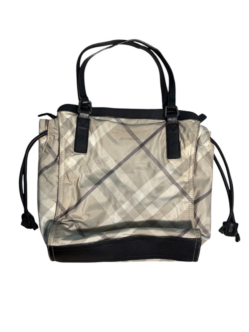 Burberry Buckleigh Nylon Tote Bag (Category: Luxury Bags & Wallets) located in Cagayan de Oro. Submitted by thatsdopethrift (Listing ID 1463878968, Image 3). Description: Authentic Burberry Buckleigh tote bag featuring the iconic mega check plaid pattern. This practical shoulder bag is crafted from lightweight, water-resistant nylon canvas with structured leather trimmings. Designed with adjustable side drawstrings to alter the bag’s silhouette a