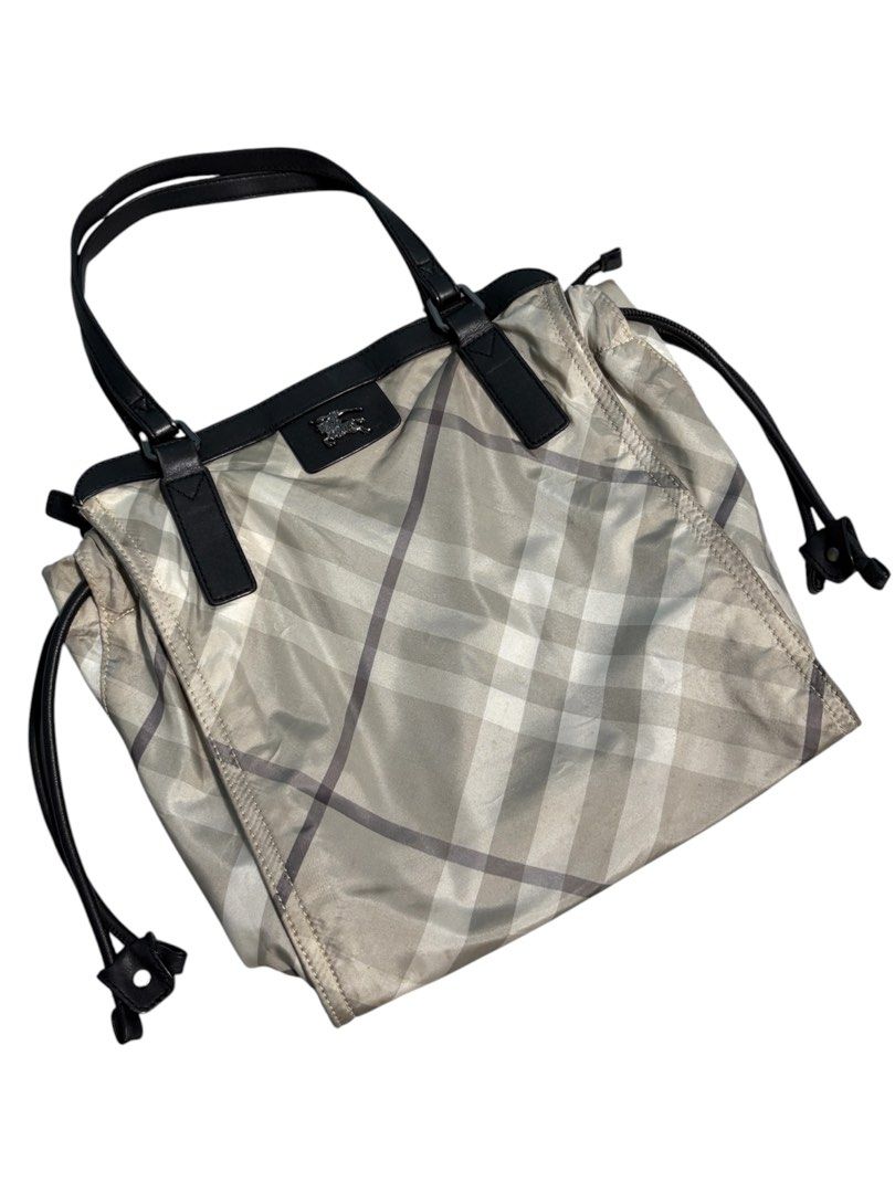 Burberry Buckleigh Nylon Tote Bag (Category: Luxury Bags & Wallets) located in Cagayan de Oro. Submitted by thatsdopethrift (Listing ID 1463878968, Image 2). Description: Authentic Burberry Buckleigh tote bag featuring the iconic mega check plaid pattern. This practical shoulder bag is crafted from lightweight, water-resistant nylon canvas with structured leather trimmings. Designed with adjustable side drawstrings to alter the bag’s silhouette a