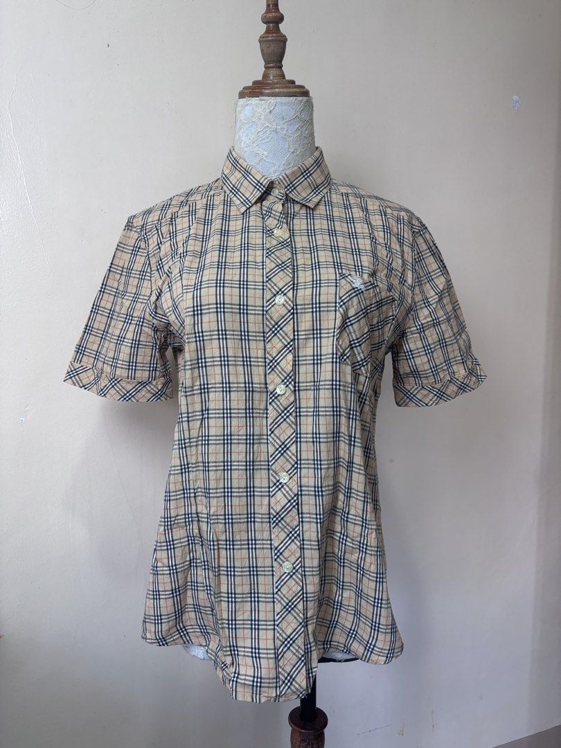 Burberry Nova Check Short Sleeve Shirt (Category: Shirts) located in Manila. Submitted by galitsabarat (Listing ID 1463745311, Image 1). Description: VINTAGE - Classic Burberry short sleeve shirt - Features iconic Nova Check pattern - Button-up front - Chest pocket - Comfortable and stylish - Perfect for casual or dressed-up looks.
