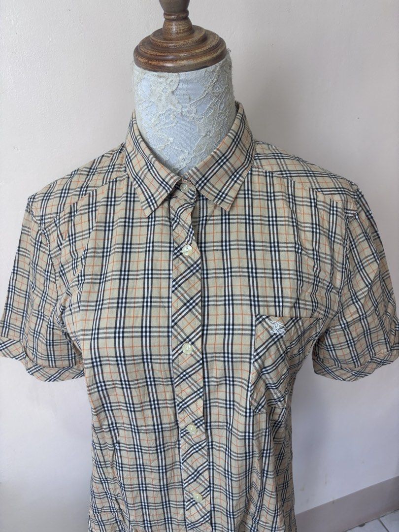 Burberry Nova Check Short Sleeve Shirt (Category: Shirts) located in Manila. Submitted by galitsabarat (Listing ID 1463745311, Image 2). Description: VINTAGE - Classic Burberry short sleeve shirt - Features iconic Nova Check pattern - Button-up front - Chest pocket - Comfortable and stylish - Perfect for casual or dressed-up looks.