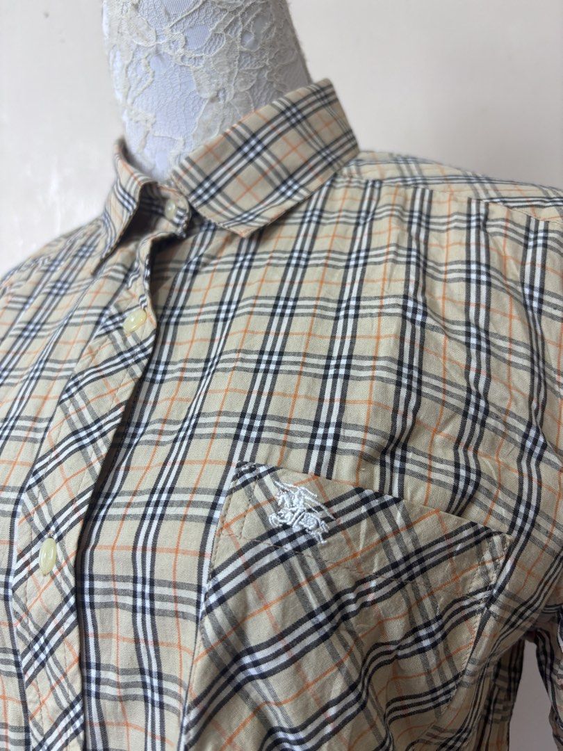 Burberry Nova Check Short Sleeve Shirt (Category: Shirts) located in Manila. Submitted by galitsabarat (Listing ID 1463745311, Image 3). Description: VINTAGE - Classic Burberry short sleeve shirt - Features iconic Nova Check pattern - Button-up front - Chest pocket - Comfortable and stylish - Perfect for casual or dressed-up looks.