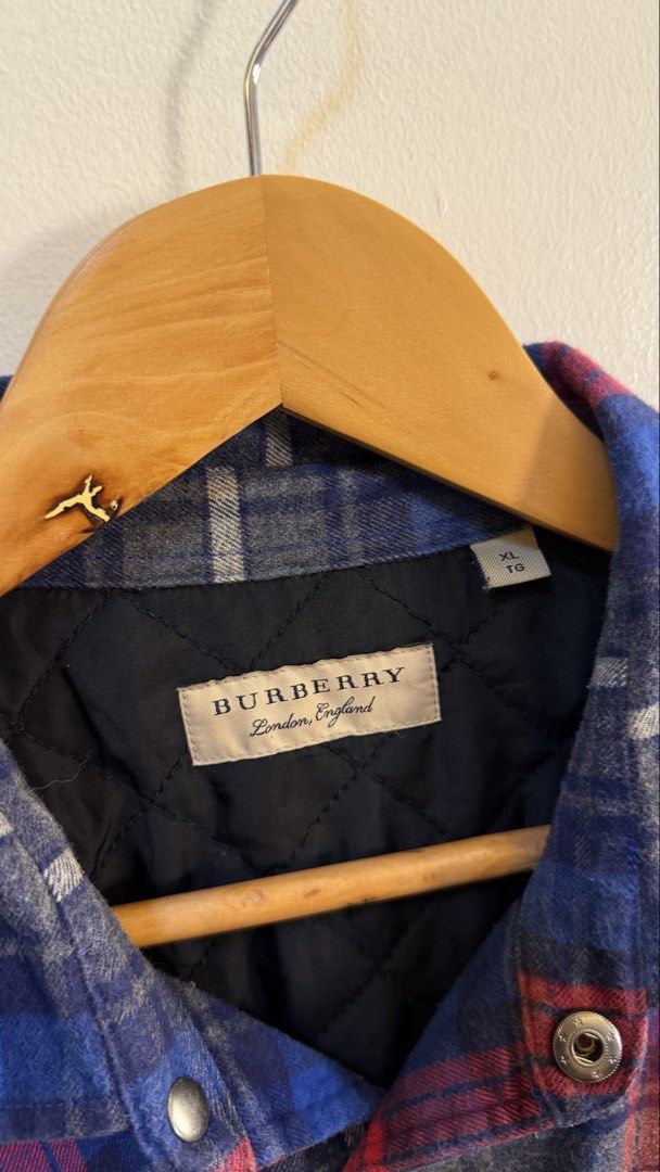 Burberry Plaid Flannel Shirt (Category: Longsleeves) located in Paranaque City. Submitted by mykapoynton (Listing ID 1463872730, Image 3). Description: Burberry Plaid Flannel Shirt - Blue, red, and grey checkered pattern - Quilted lining for extra warmth - Two chest pockets with button closure - Size XL - Made in China.