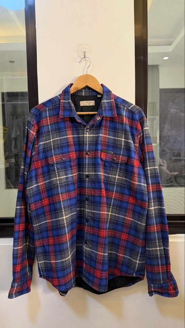 Burberry Plaid Flannel Shirt (Category: Longsleeves) located in Paranaque City. Submitted by mykapoynton (Listing ID 1463872730, Image 2). Description: Burberry Plaid Flannel Shirt - Blue, red, and grey checkered pattern - Quilted lining for extra warmth - Two chest pockets with button closure - Size XL - Made in China.