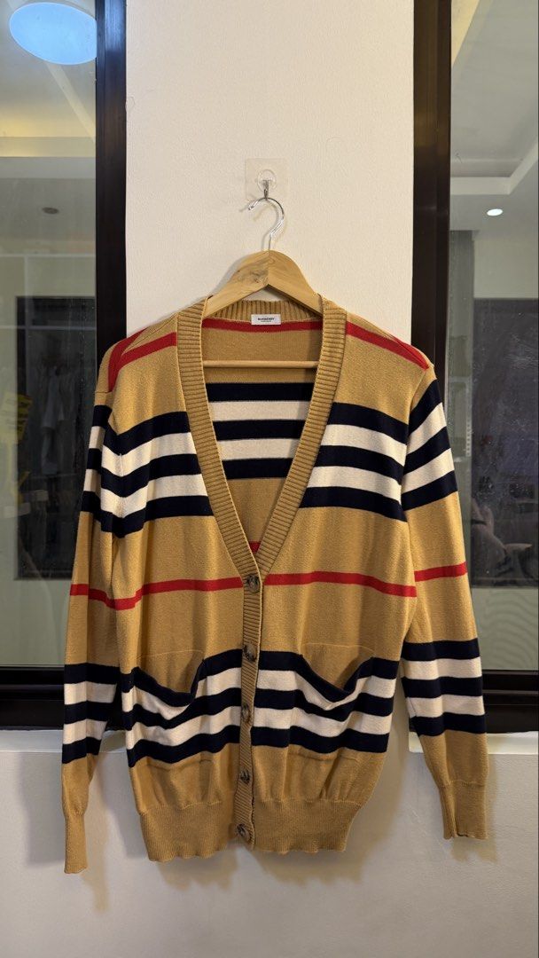 Burberry Striped Knit Cardigan (Category: Longsleeves) located in Paranaque City. Submitted by mykapoynton (Listing ID 1463882575, Image 2). Description: Burberry Striped Knit Cardigan - Iconic stripe pattern - V-neck design - Button-up front - Two front pockets - Material: Cashmere, Polyester, Nylon blend - Ideal for layering.